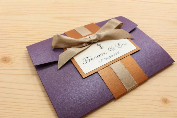 Cadbury purple pocketfold wedding invitation with a tied ribbon bow and sparkly crystals